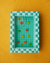 Load image into Gallery viewer, miniature pool with green tiles and fall leaves suspended in the resin water
